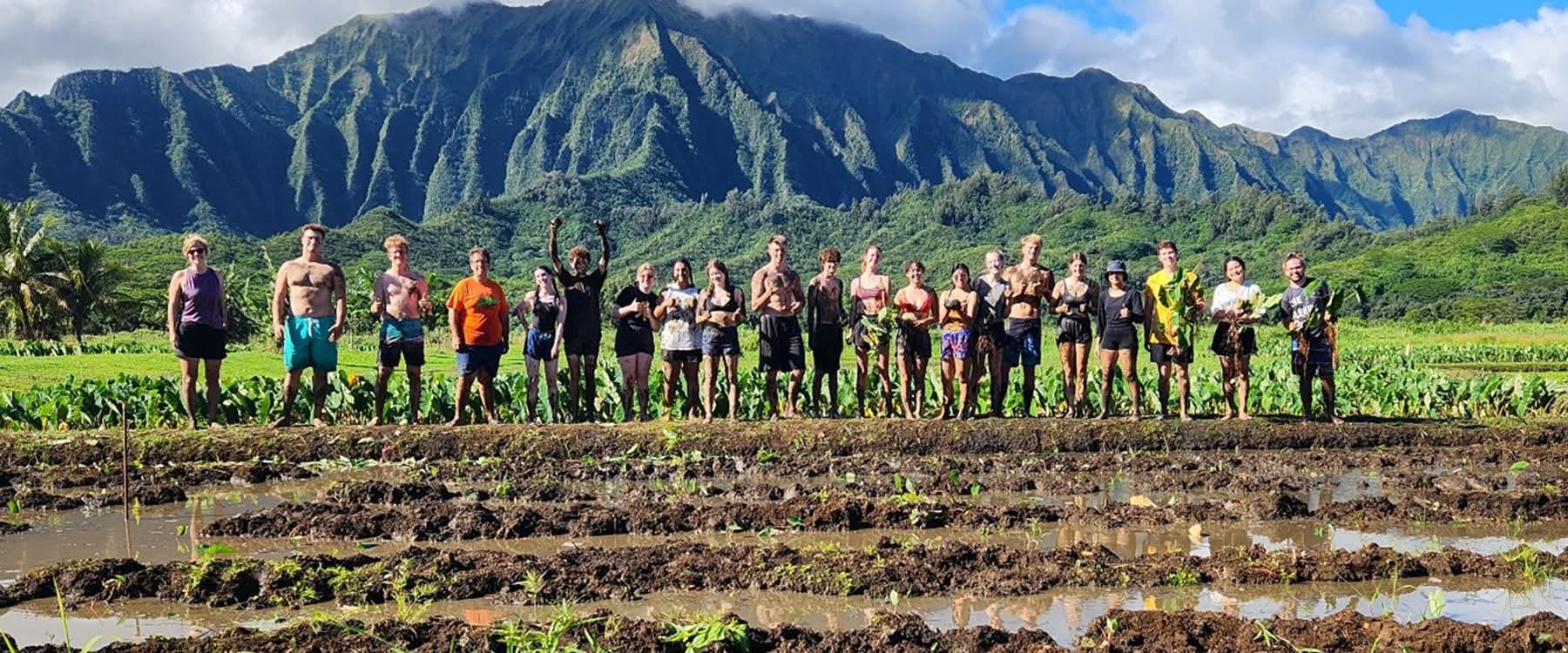 Students group photo with mountains and trees in the background.