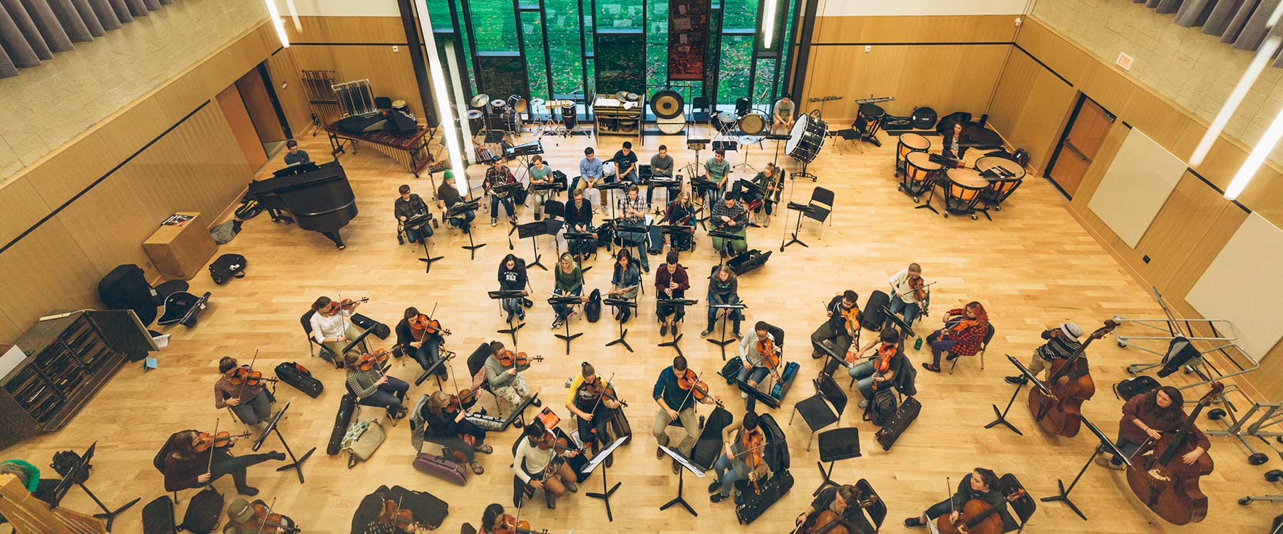 A view from the ceiling looking down at symphony students rehearsing in Cowles Music Center.